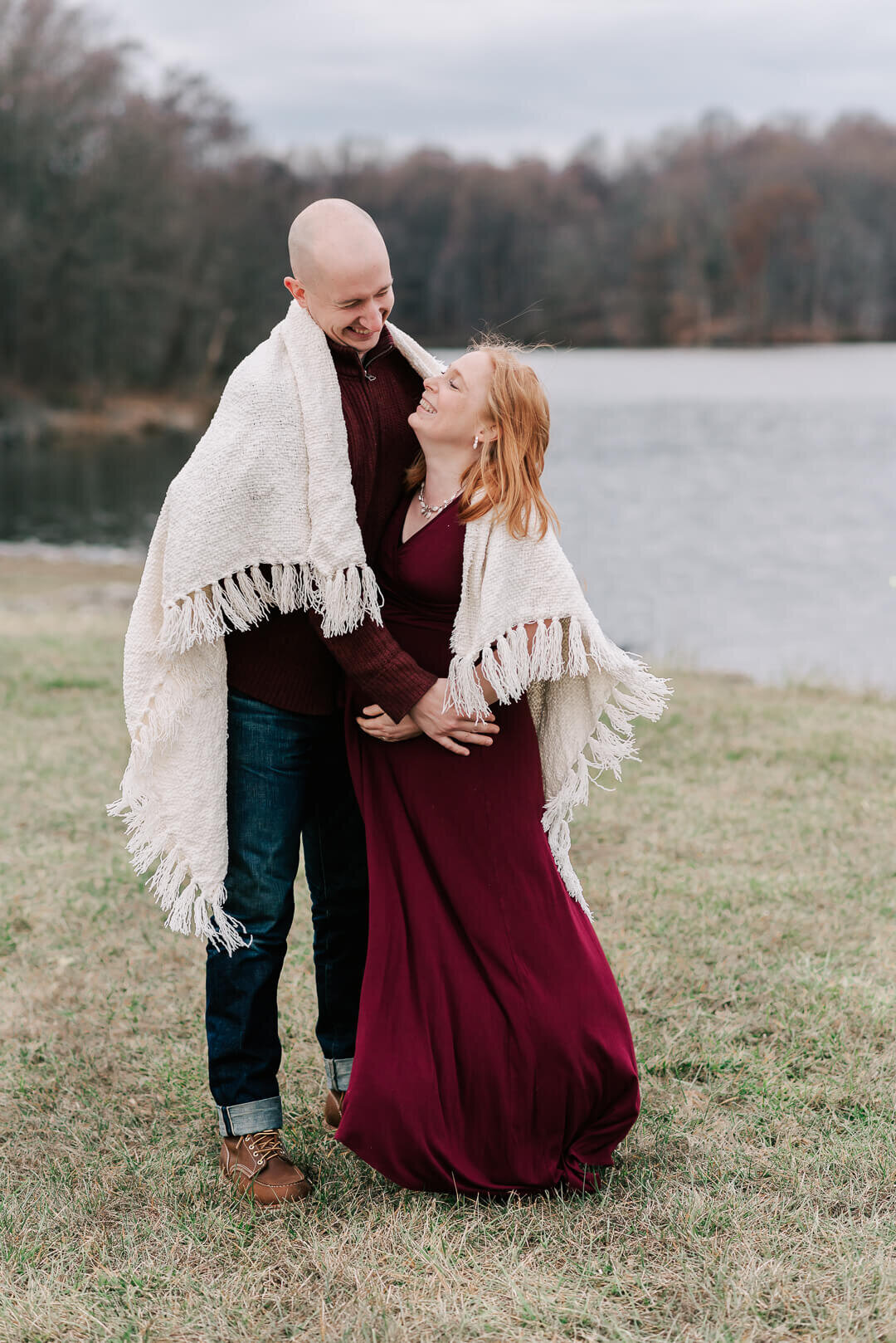 Soon-to-be parents laughing during their maternity session with northern virginia maternity photographer