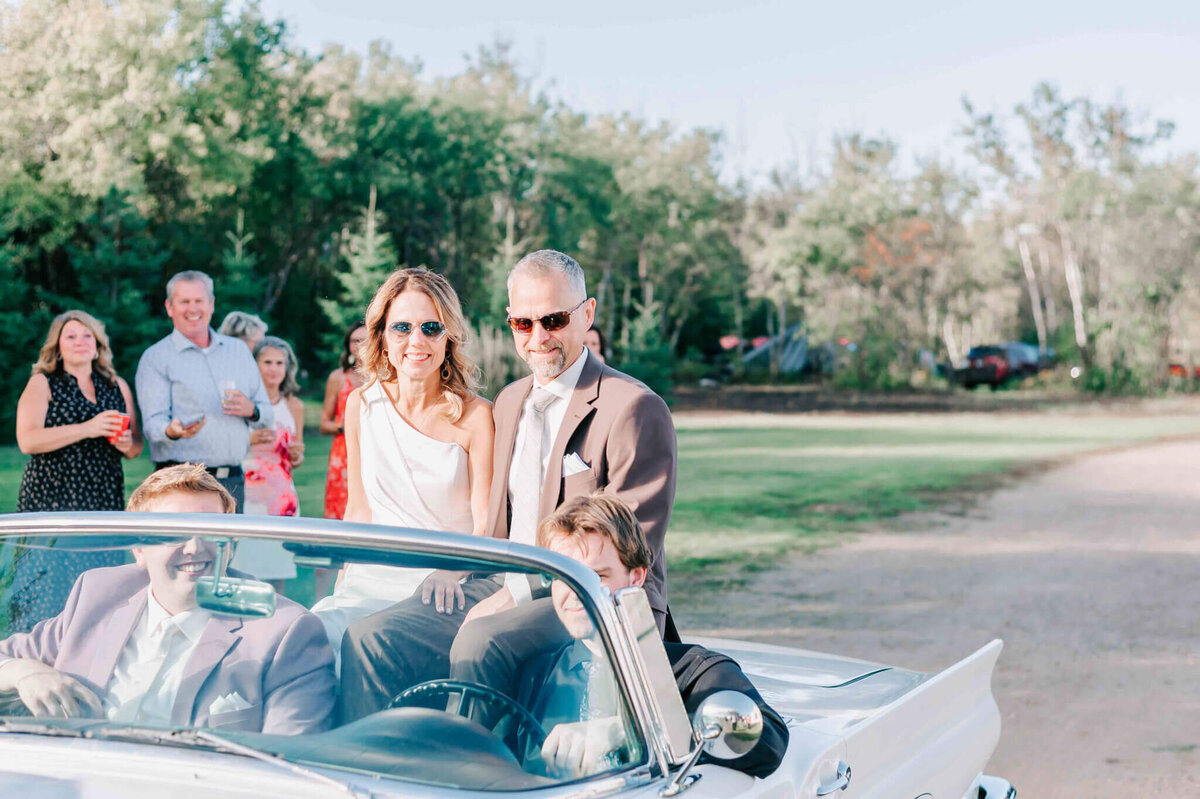 Bride and groom arrive to their wedding in a Ford Thunderbird.