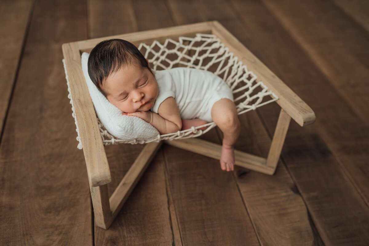 newborn boy posed on hammock prop at studio in St. Pete