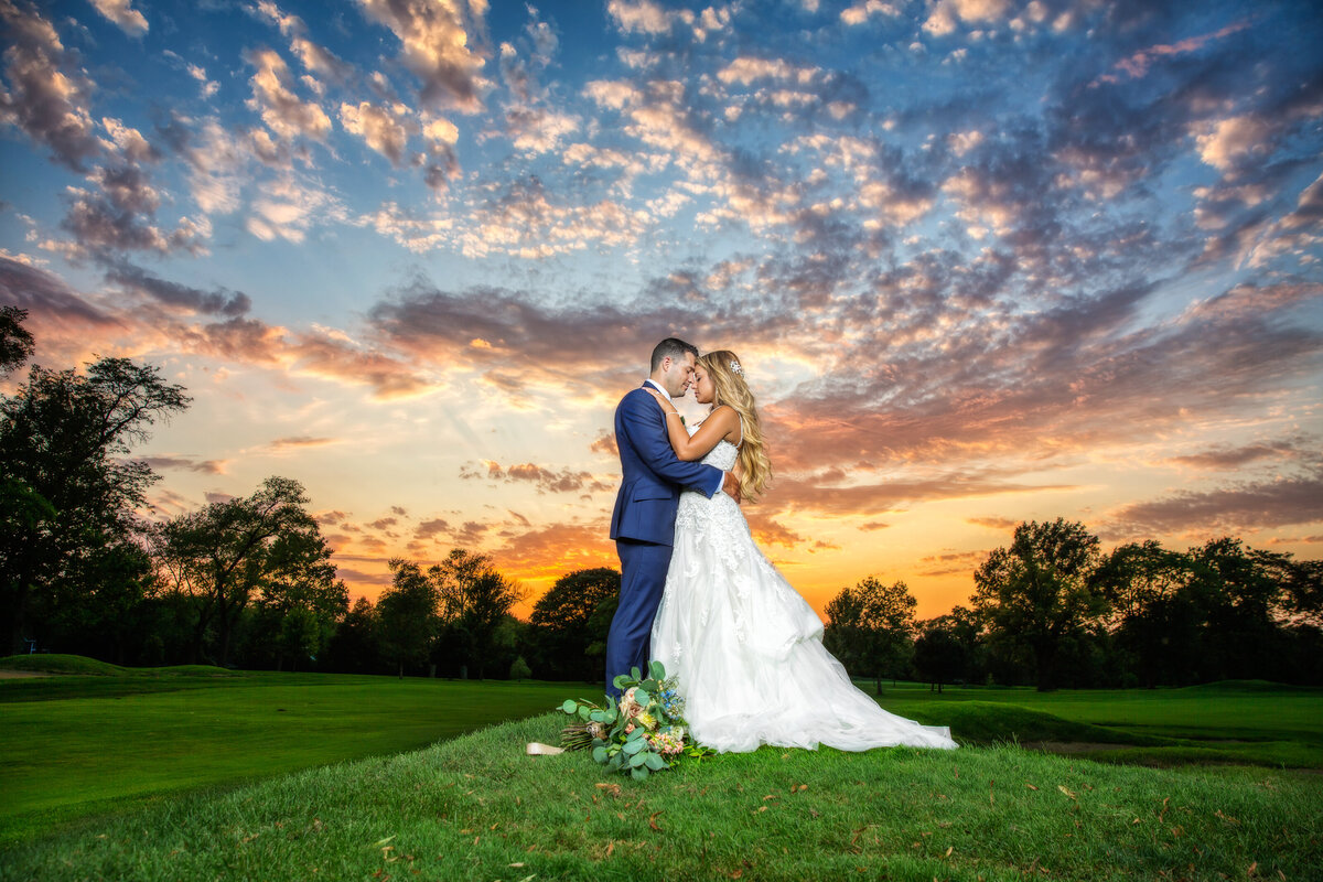 A sunset couple portrait at an outdoor wedding at Ravisloe Country Club.