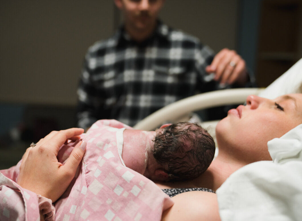 A mother relaxes with her new baby.