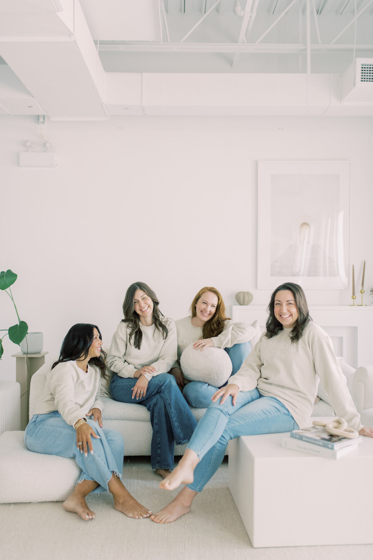 Candid moment of laughter between cosmetic team members in neutral tones—branding joy
