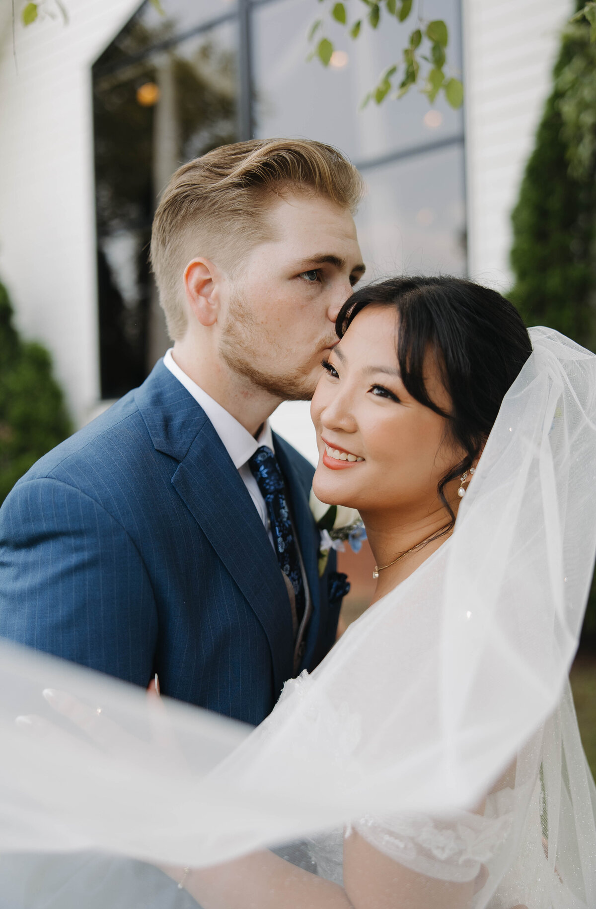 Groom Kissing Brides temple after their wedding ceremony