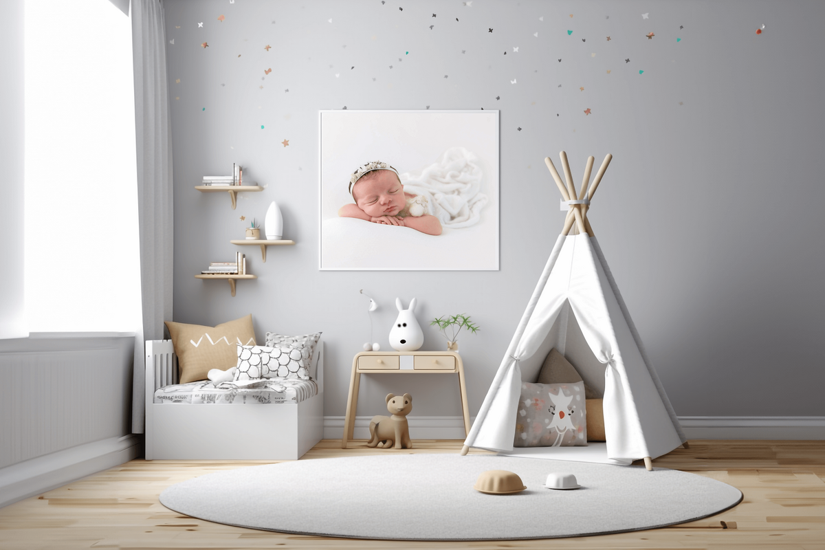 grey nursery room with a framed photo of a newborn girl for her newborn photography session