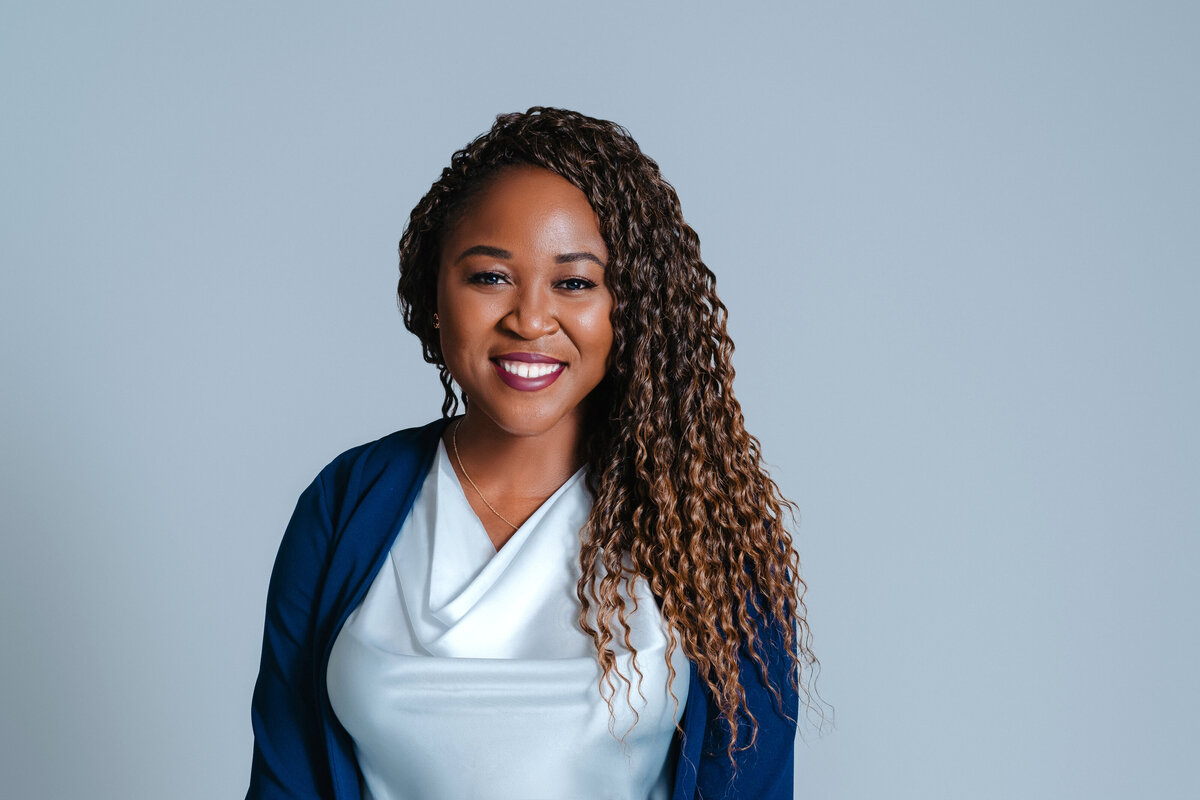 A woman in a blue blazer smiling