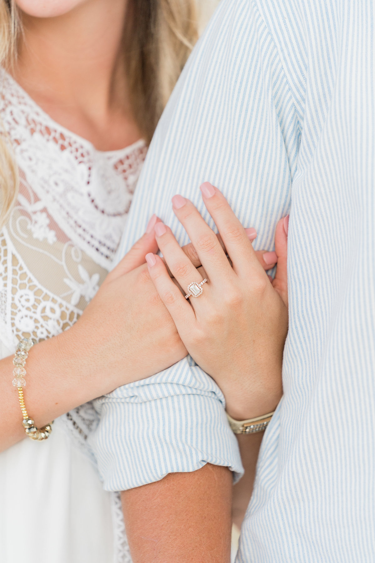 Engagement photo with woman holding man's arm