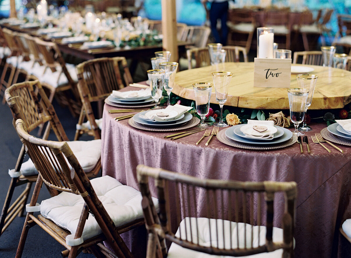 Family style dinner hack: low wooden shelves with flowers, greenery, and fruit peeking out underneath. Nashville and RT Lodge wedding floral design.