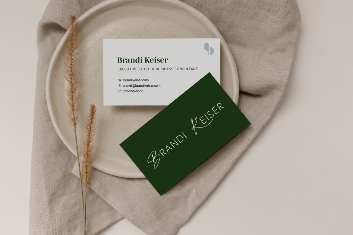 Minimalist business card design with typographic logo for Brandi Keiser on a ceramic plate and piece of fabric