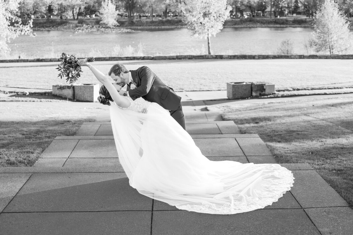 Groom dipping and kissing his bride in Baker Park