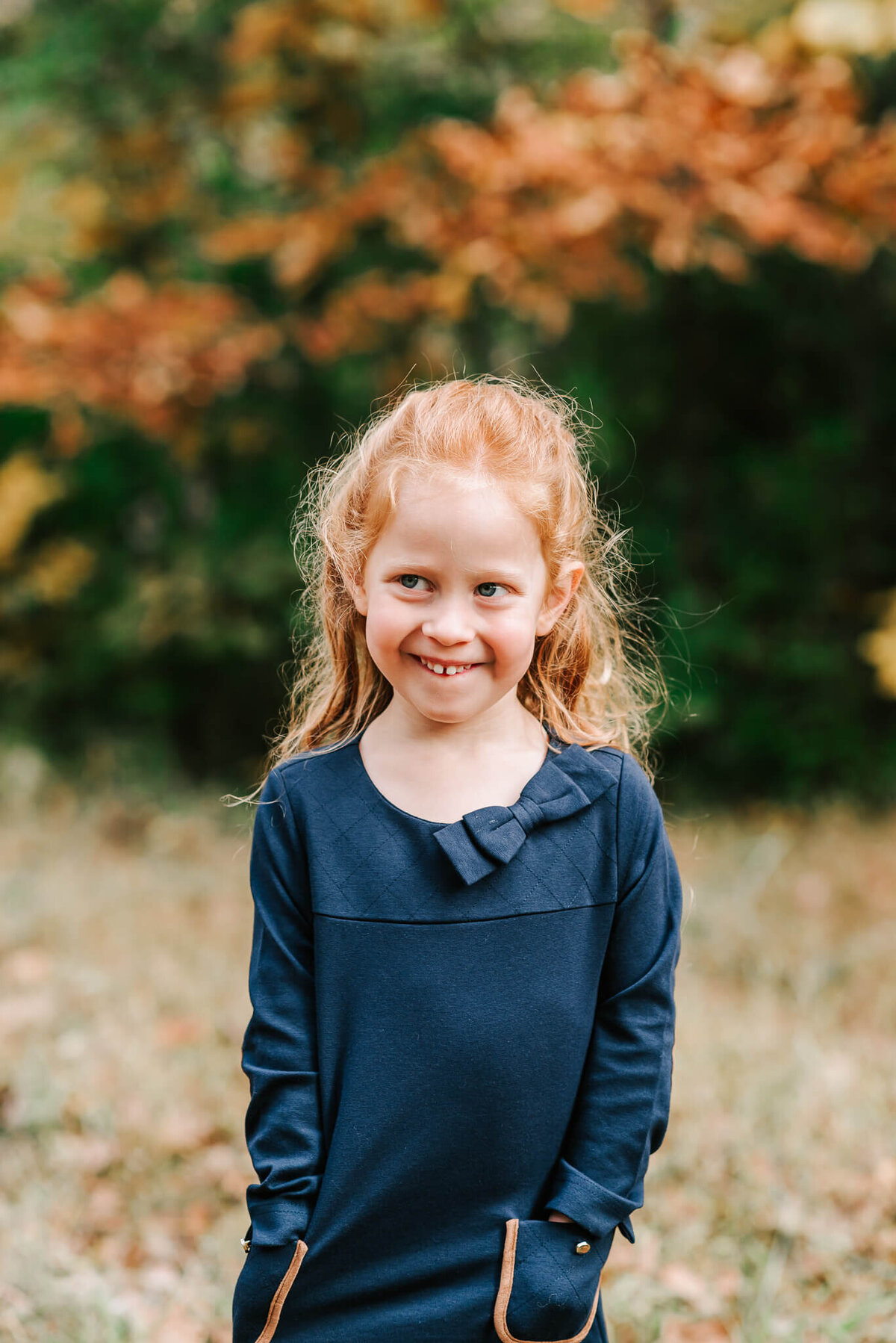Fall portrait of a redheaded girl in a navy dress in northern virginia