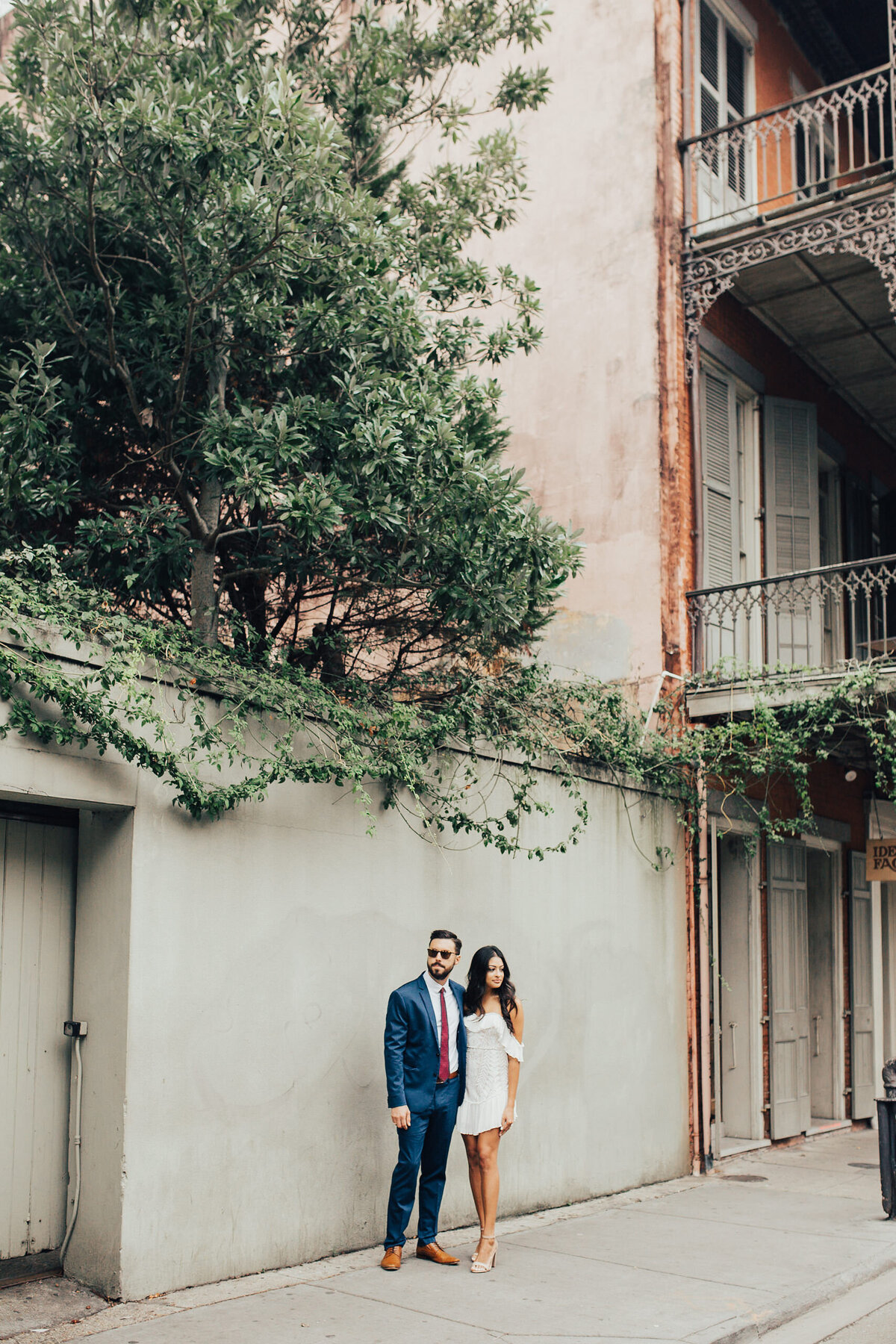 Elopement Photography, couple standing next to a large concrete wall in a city