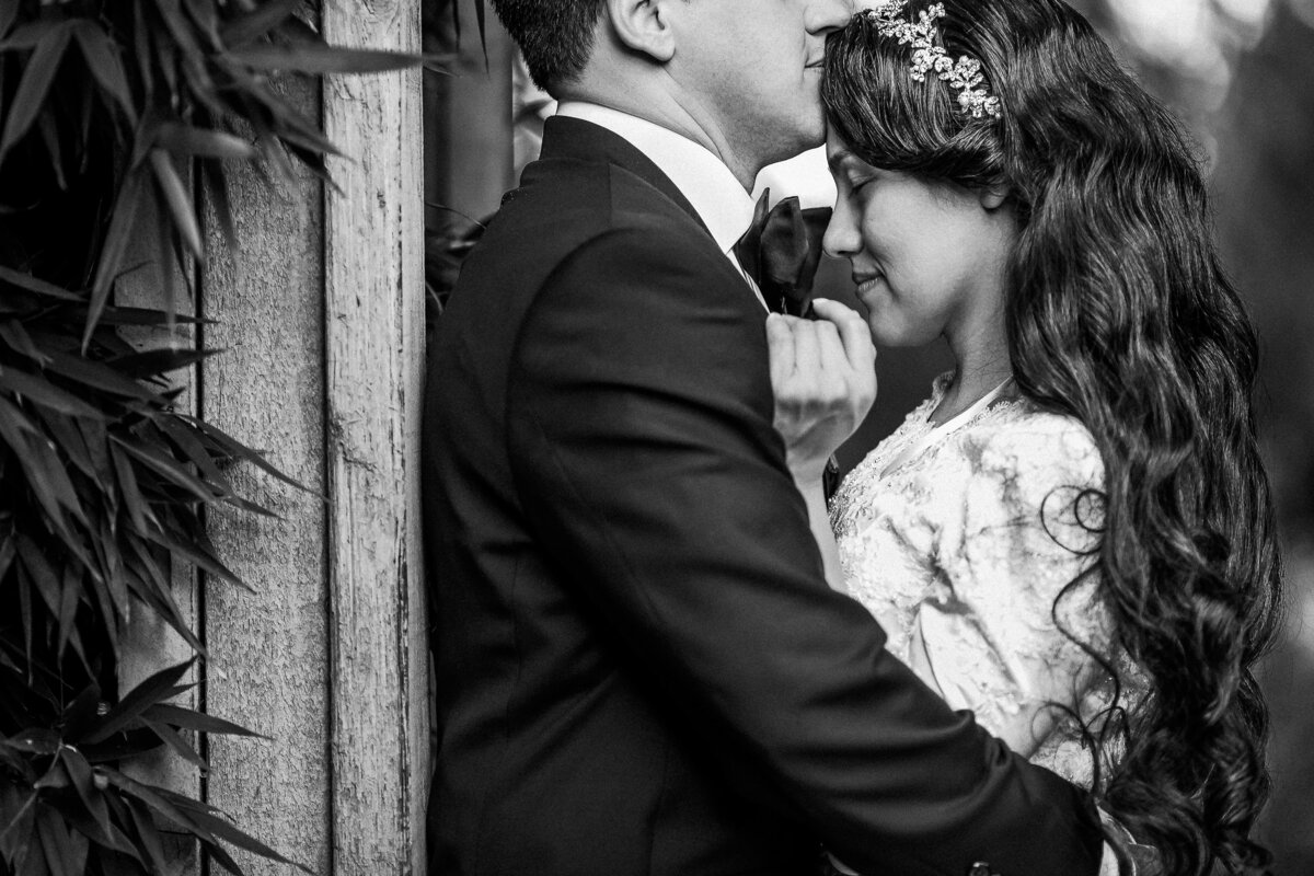 A bride and groom hold each other closely following their wedding ceremony at the Shinzen Japanese Garden in Fresno, California.