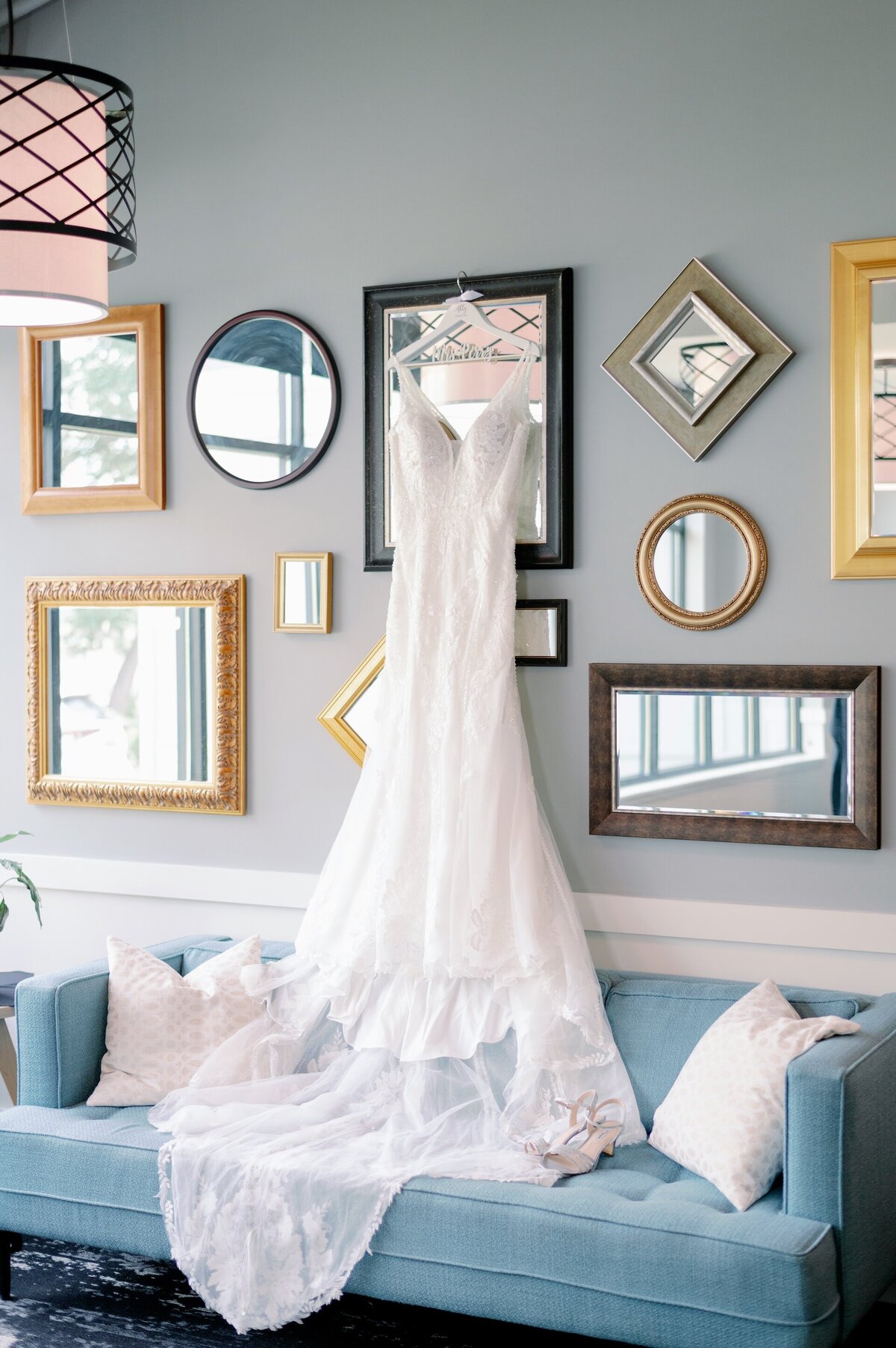 wedding dress hanging up in bride's getting suite