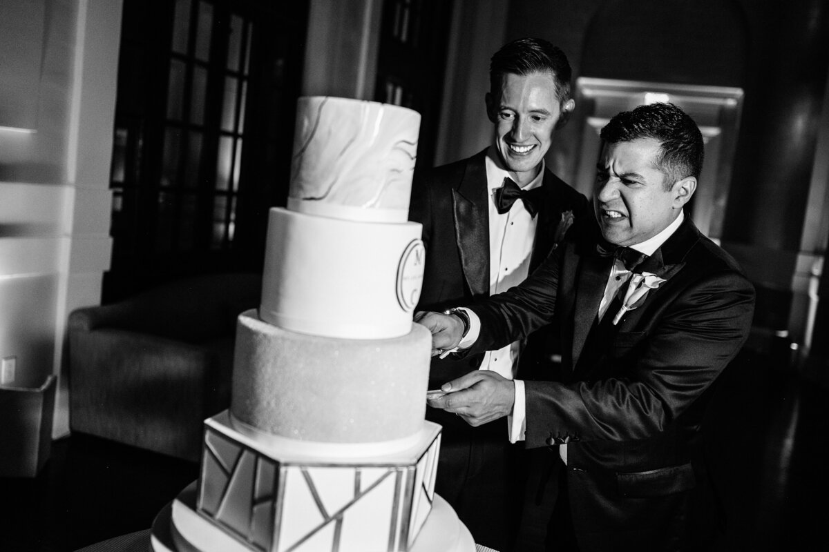 Grooms cutting the wedding cake