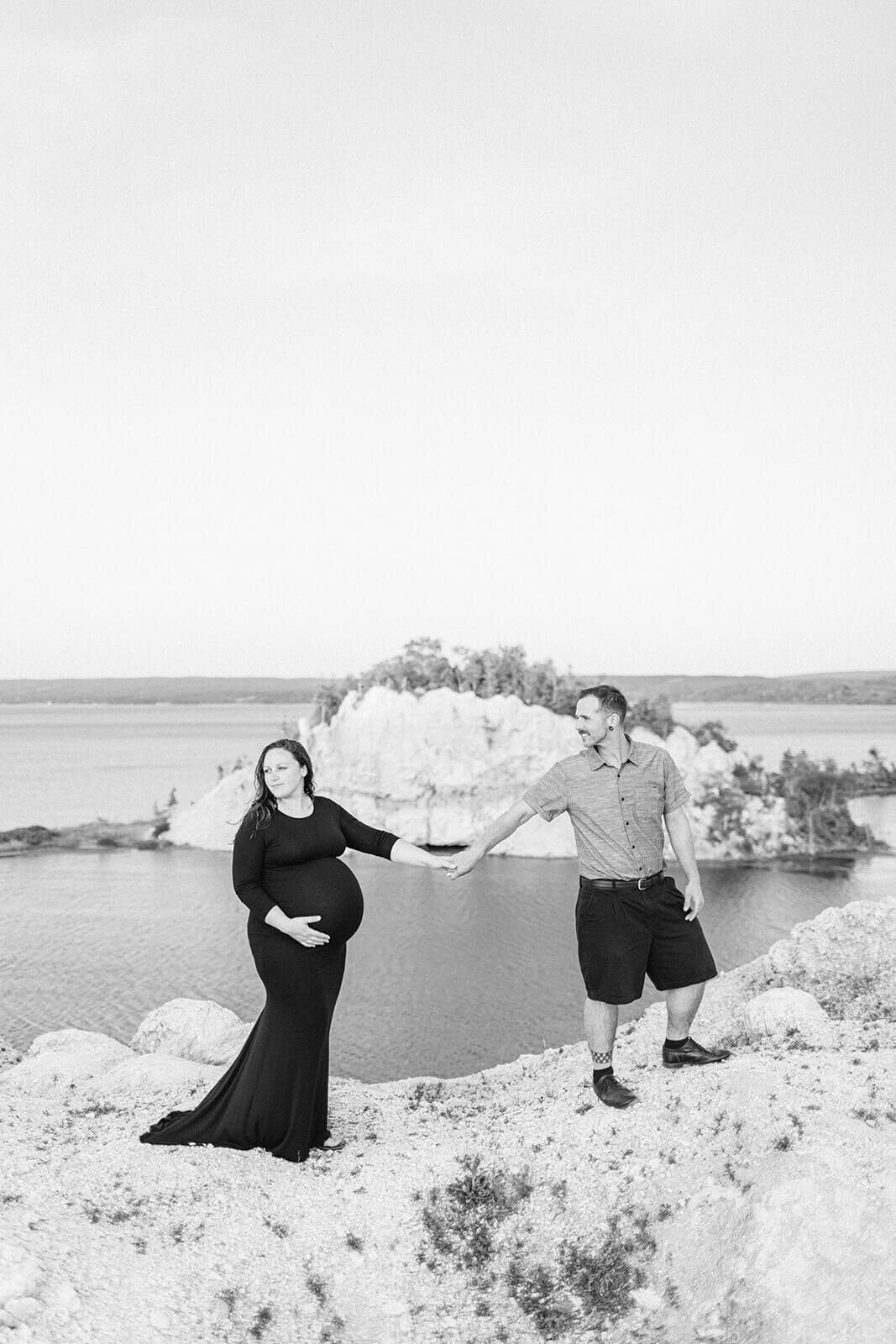 lady-in-dress-pregnanat-holding-hands-with-husband