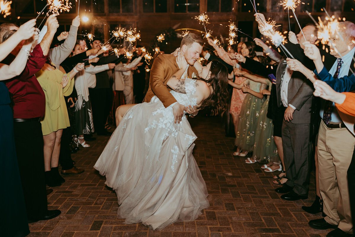 sparklers around couple as they exit their wedding