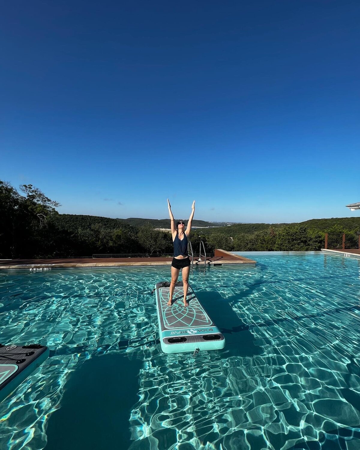 Woman doing water yoga on a board