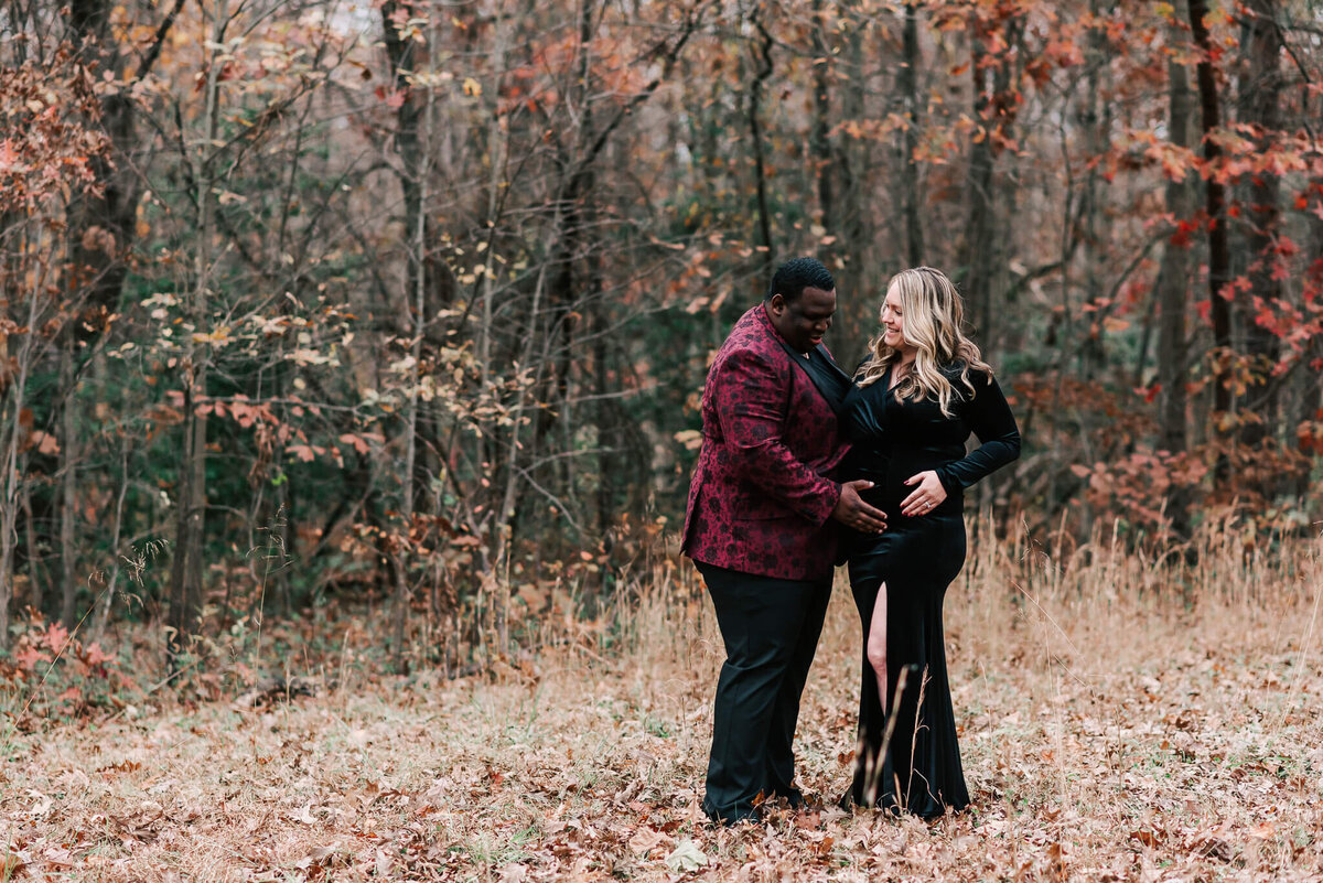An expecting couple outdoors in late autumn at Lake Fairfax Park in Northern Virginia