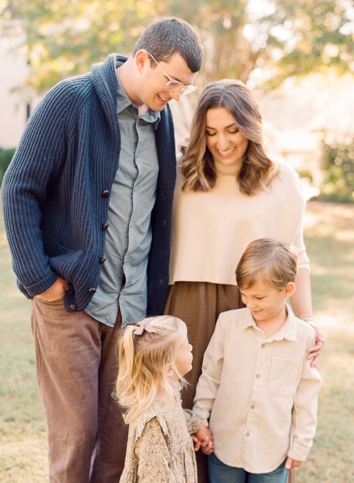 Family laughs during their raleigh portrait session. Family walking during their family portrait session in Wake Forest, NC. Photographed by Raleigh family photographer A.J. Dunlap Photography.