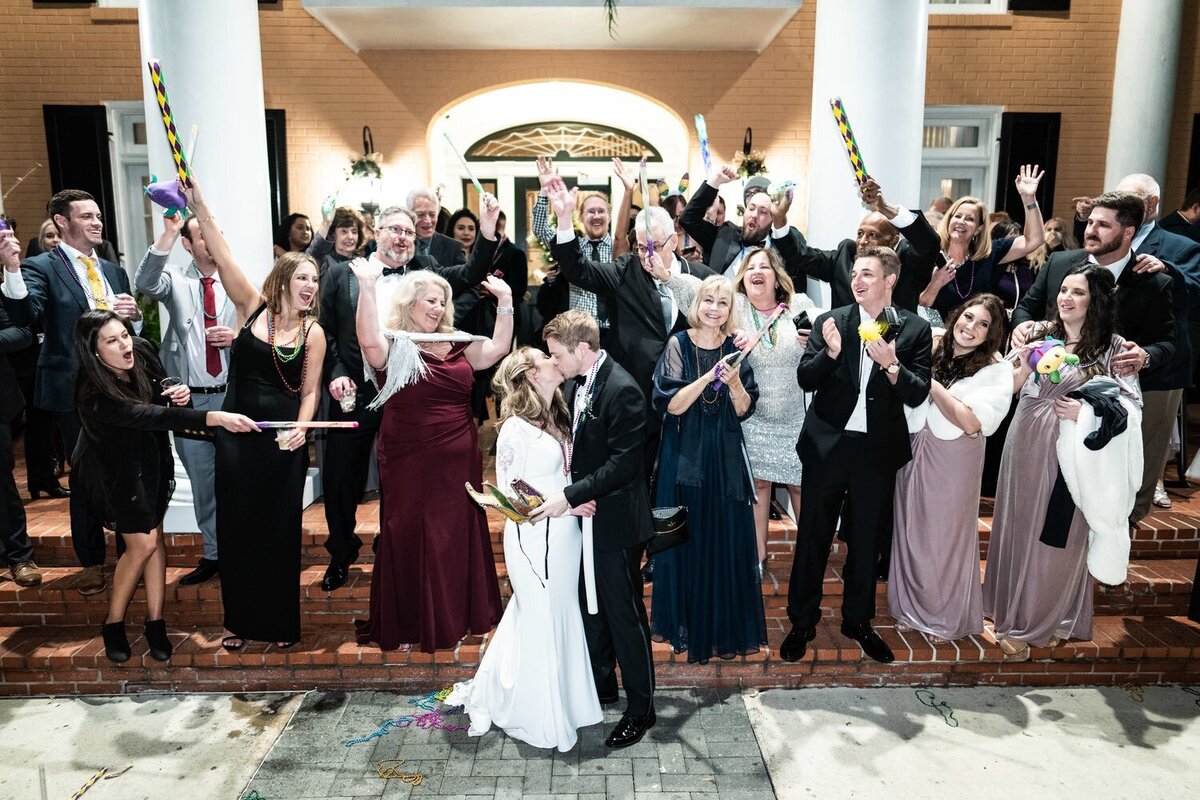 Bride and groom with guests in front of Southern Oaks