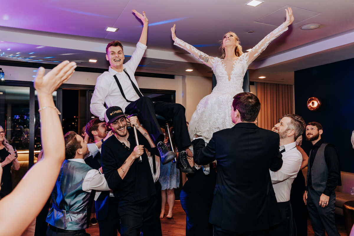 Nashville wedding photographer captures bride and groom on chairs celebrating