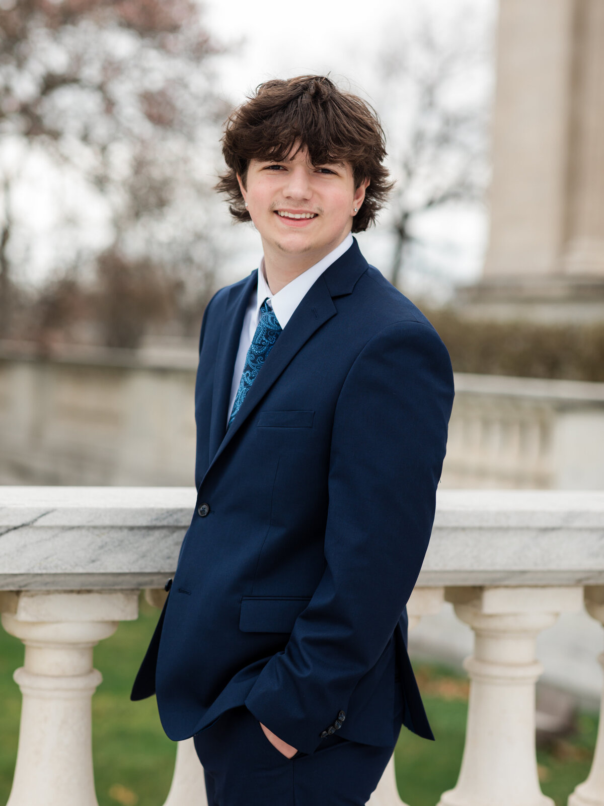 high school senior boy in blue suit posed at Cleveland Museum of Art for portraits