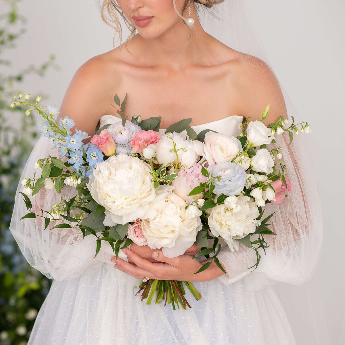 Ottawa wedding photography showing a closeup of bridal bouquet that has an assortment of white, blush and blue flowers