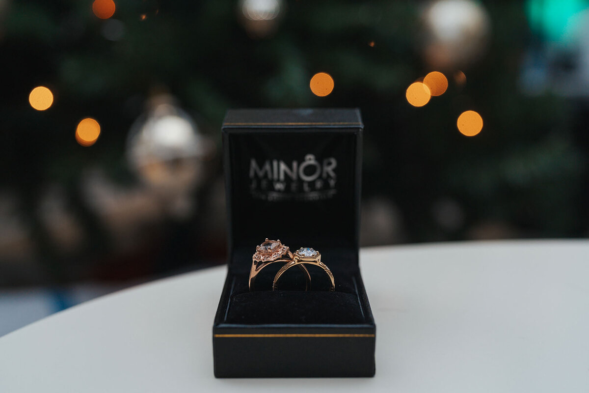 The wedding rings of two women sitting in a wooden box