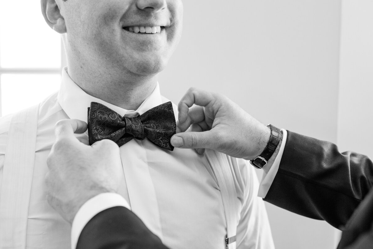 Groom getting ready before his Veuve-inspired wedding at Palmetto Bluff in Charleston, SC. Photographed by Charleston Wedding Photographer Dana Cubbage.