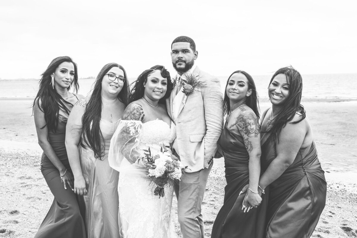 bride and groom standing with bridesmaids