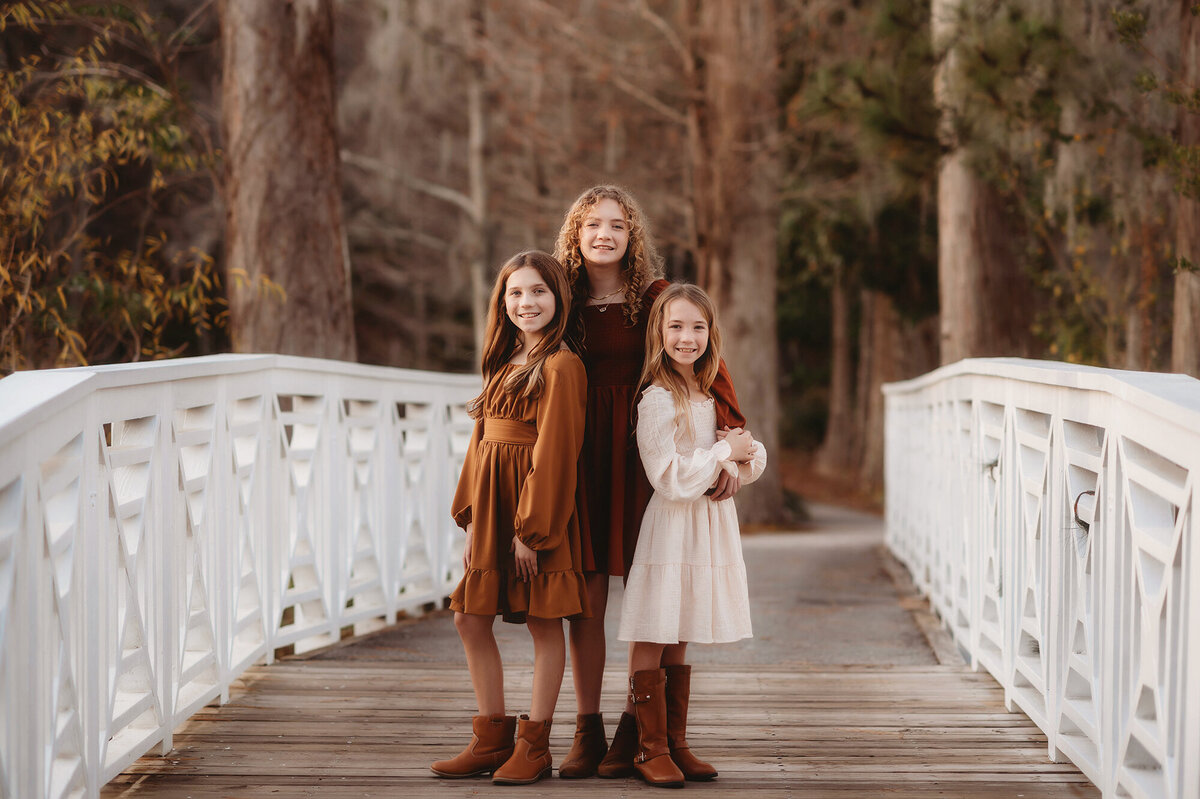 Sister embrace each other during their Family Photoshoot at Cypress Gardens near Charleston, South Carolina.