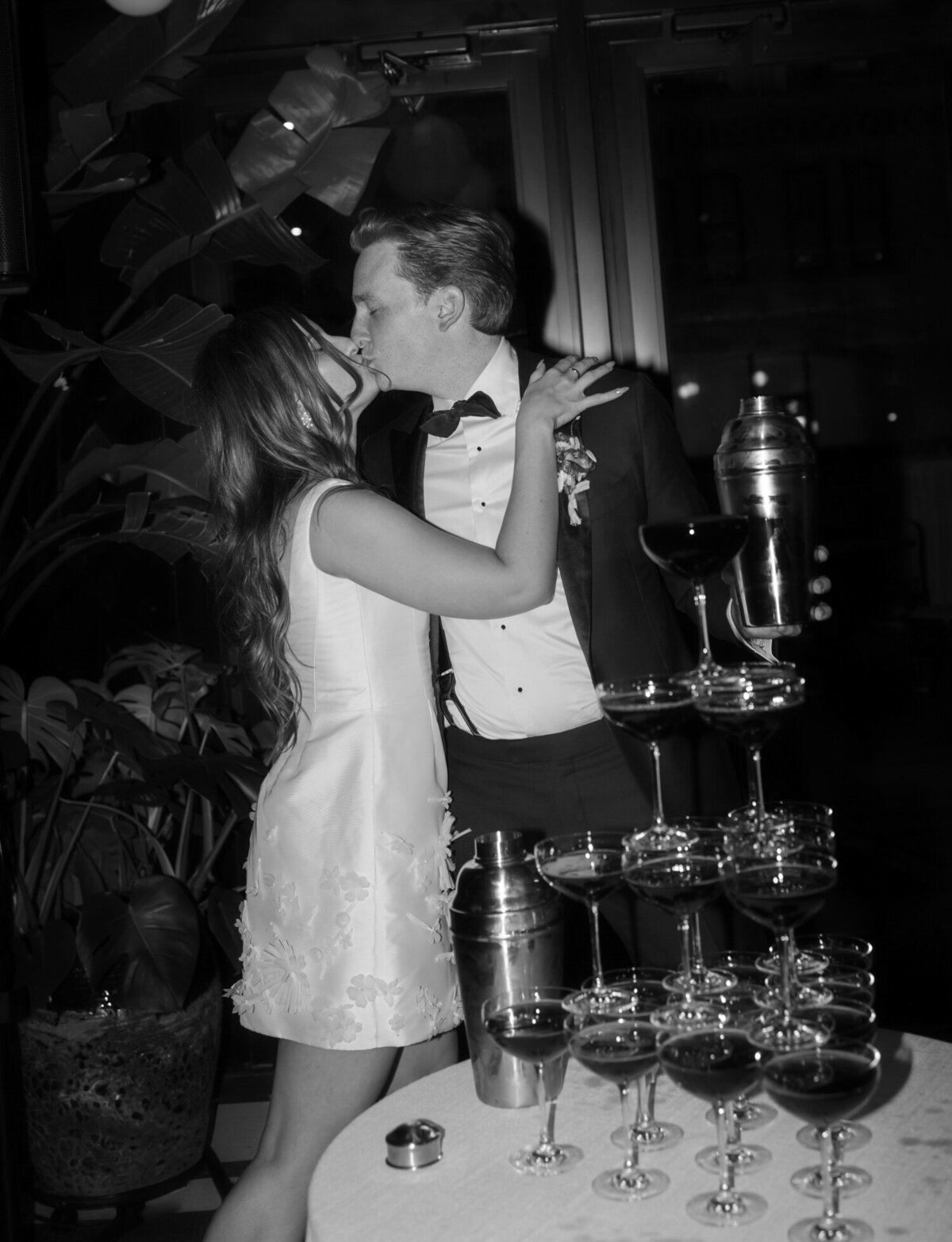 couple kisses at espresso martini tower at Shinola Hotel wedding reception, Detroit