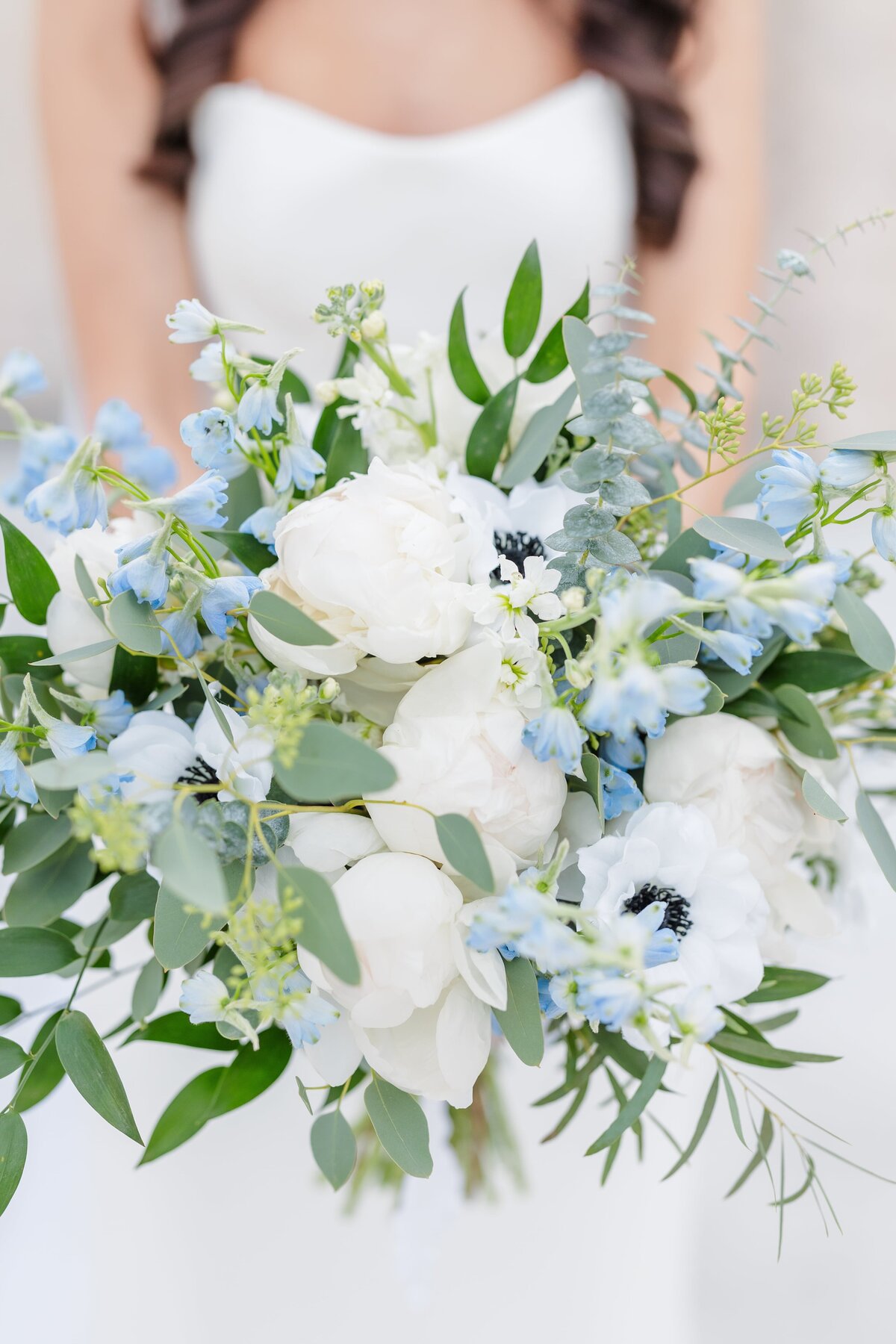 A blue and white bridal bouquet close up.