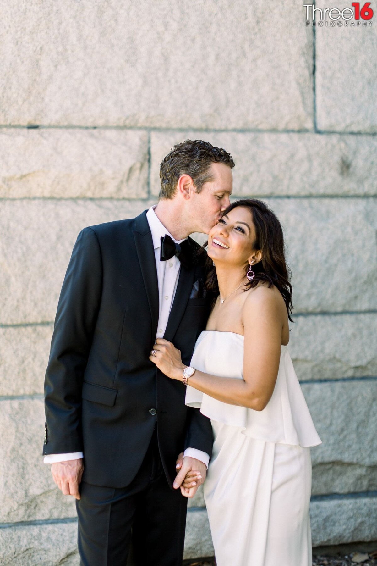 Groom kisses his Bride's head after their elopement ceremony