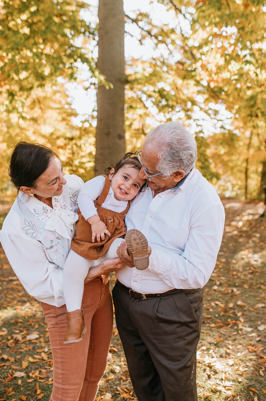 Cute-child-carried-by-grandparents