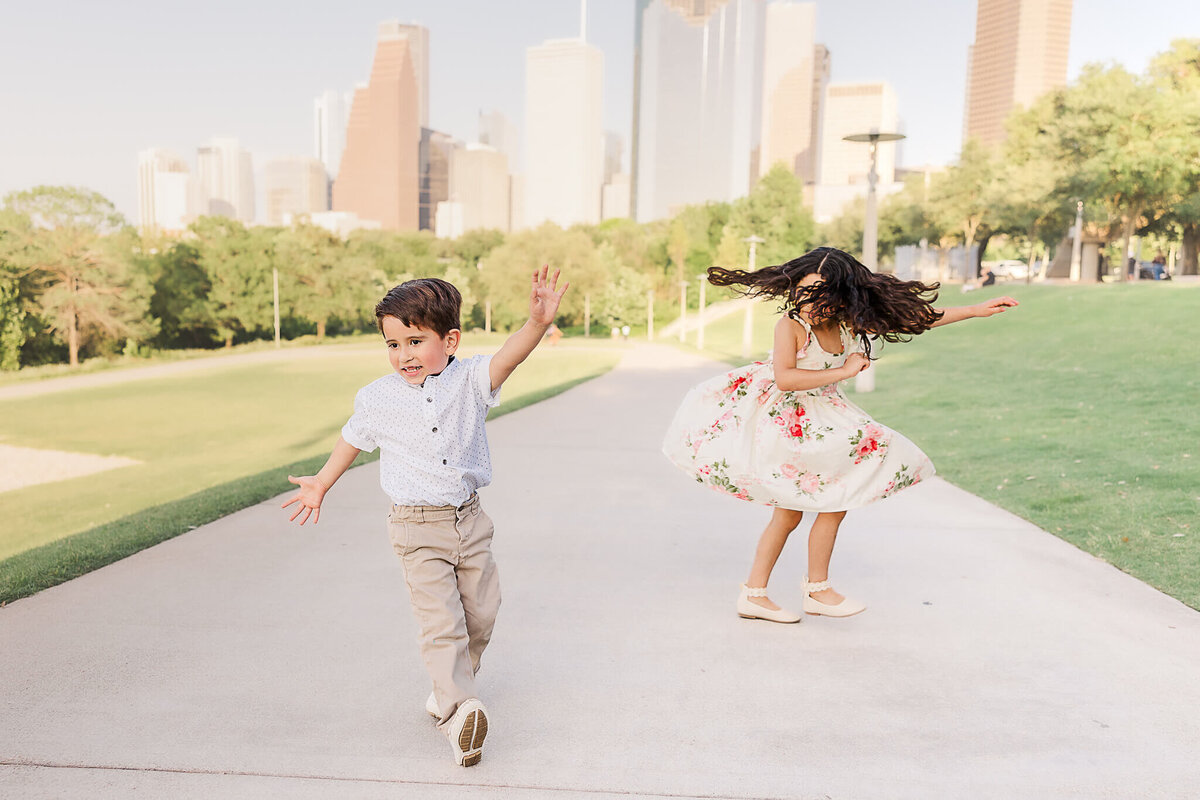 Brother and sister dancing outside