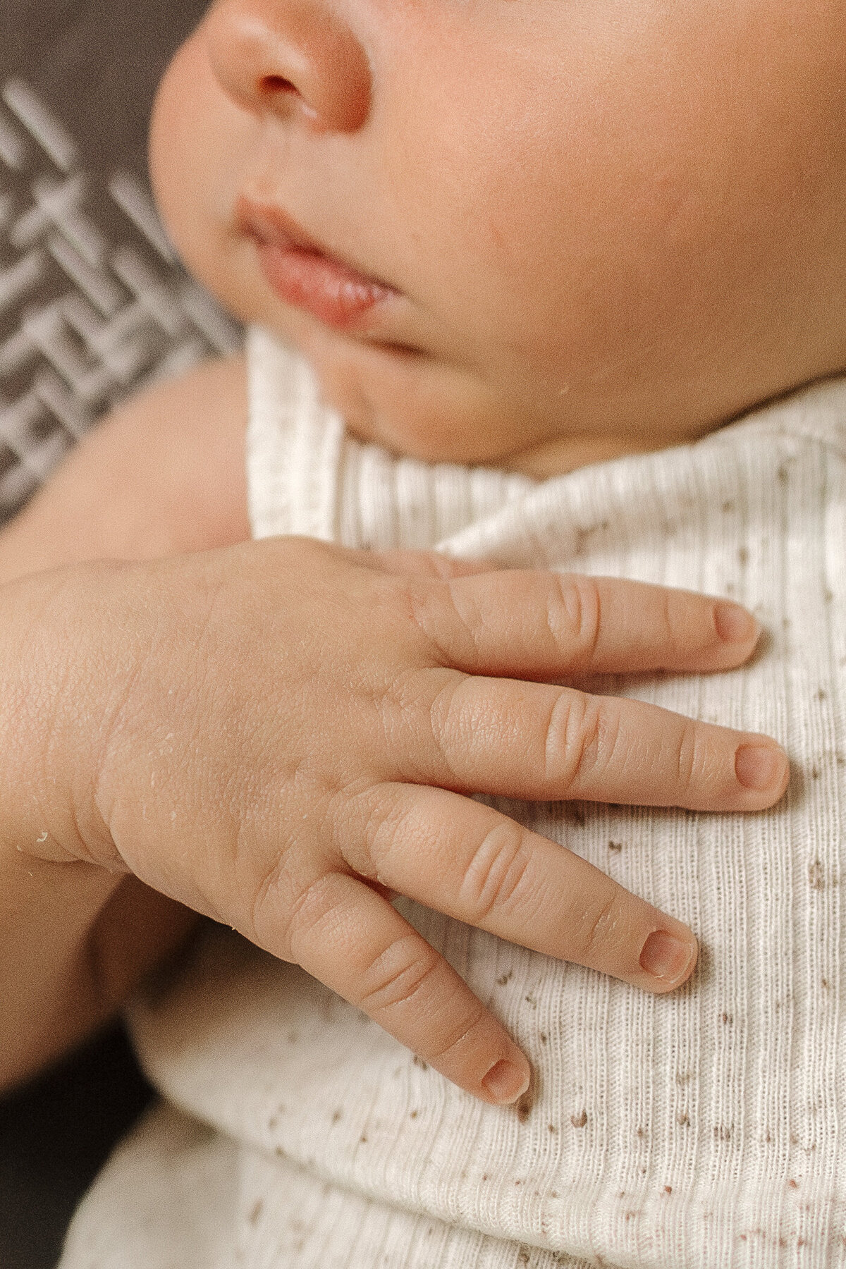 newborn nose lips fingers and hand during lifestyle in home newborn session with alexis adkins photography in longmont colorado