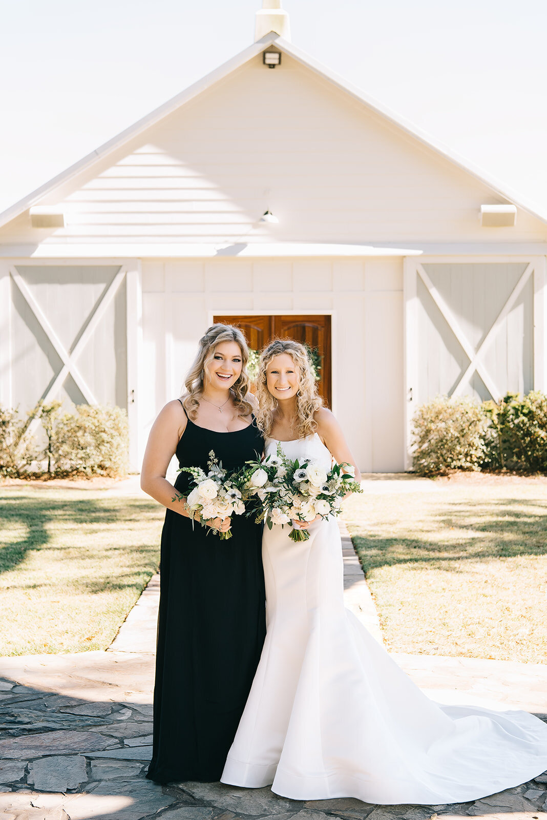 Bride and bridesmaid with white and green floral bouquets designed by Abby Grace Florals at Saluda SC wedding
