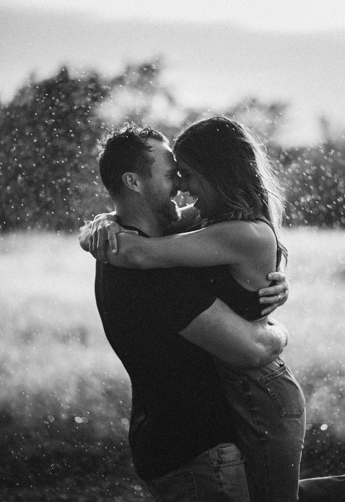 Black and white portrait of a couple backlit in coastal mist