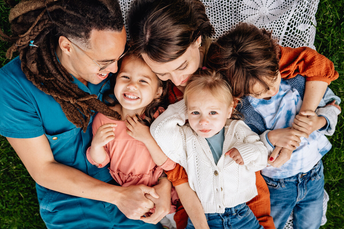 Photo from above of parents with their three kids.