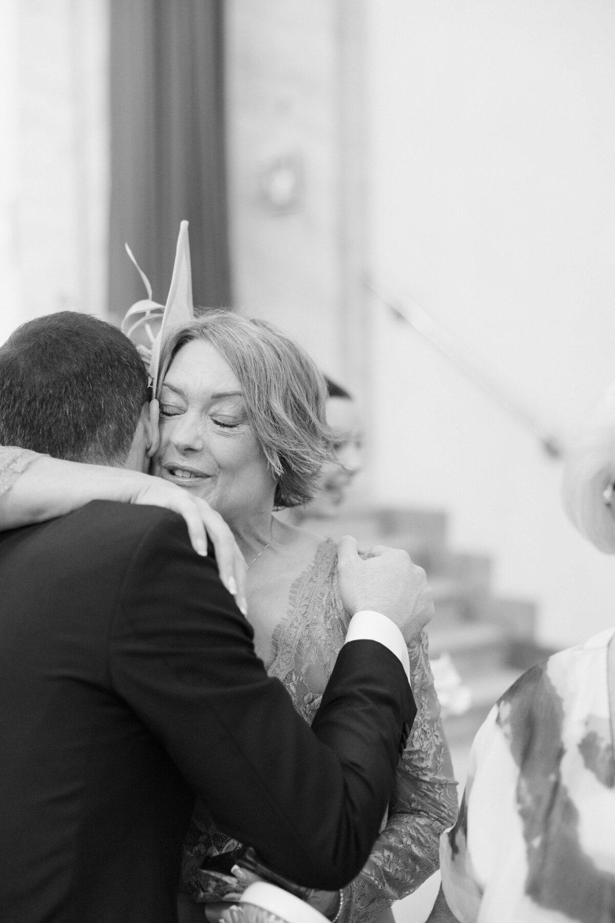 mother of bride hugging groom