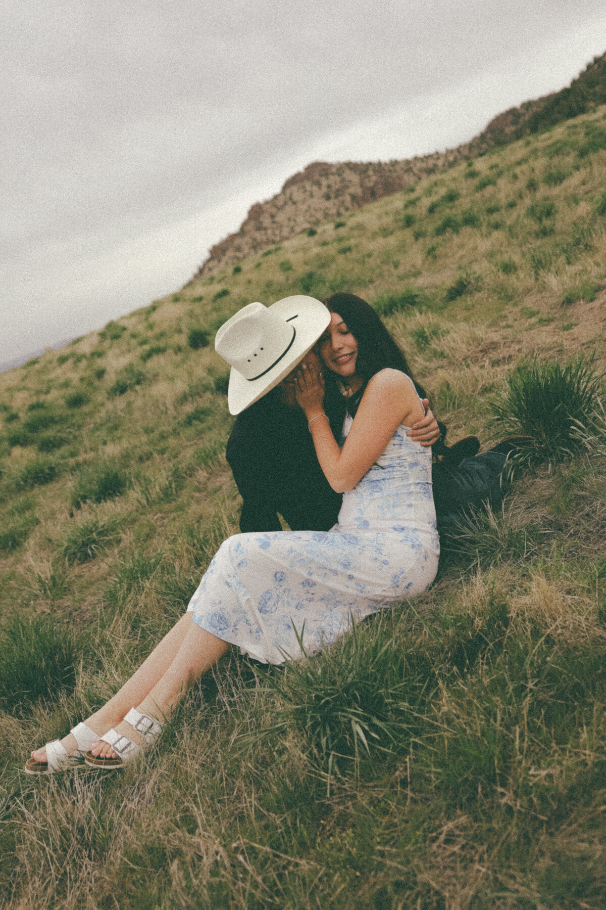 Playful Cowboy Hat Couples Session on Hillside at Golden Hour