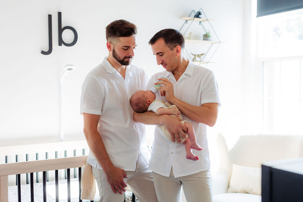 A couple feeds their newborn.