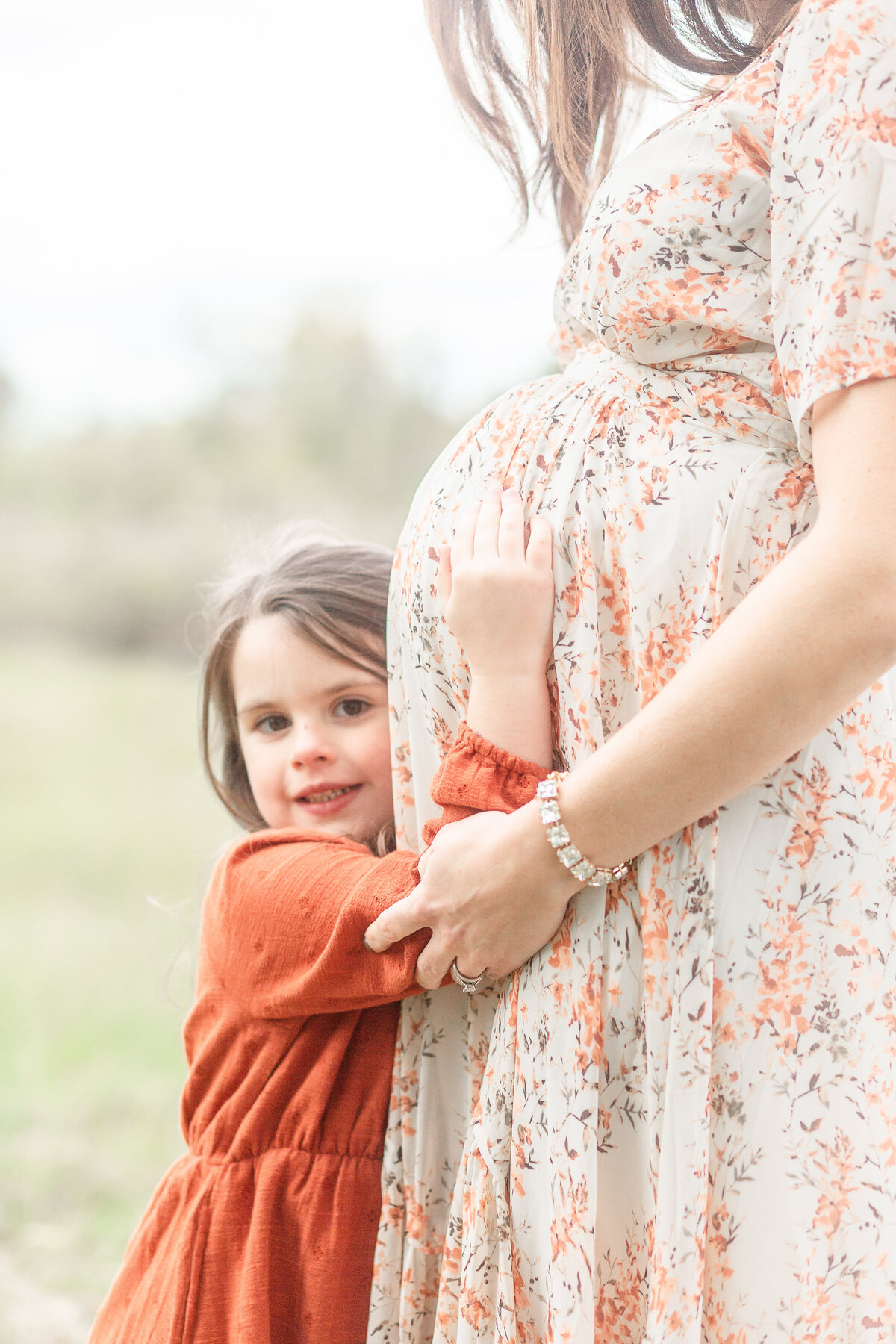 Plymouth Michigan Newborn Photographer takes photo of mom and daughter together at lifestyle maternity session