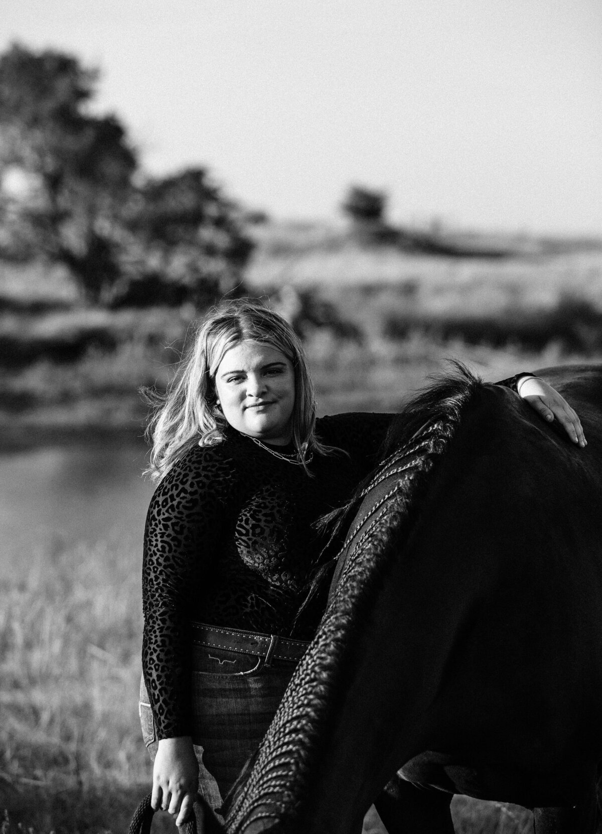 black and white photo of girl and her horse