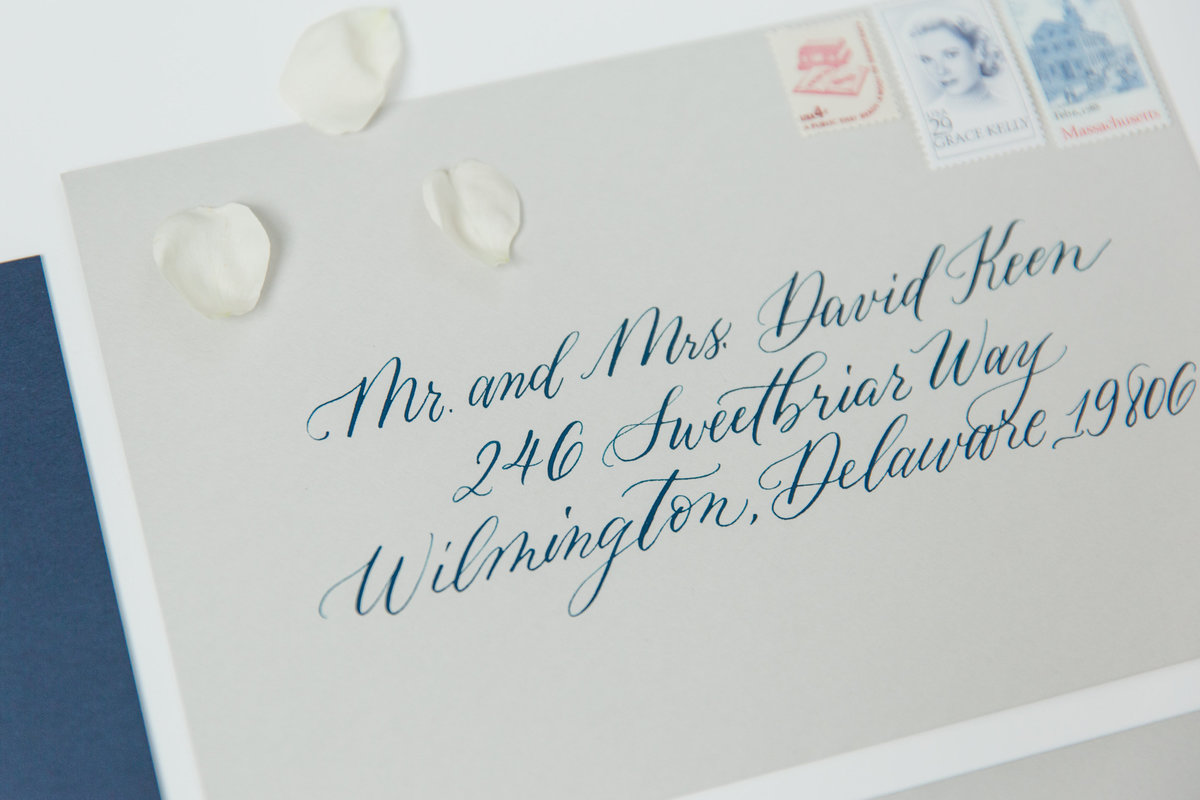 Gray envelope with calligraphy on navy blue ink