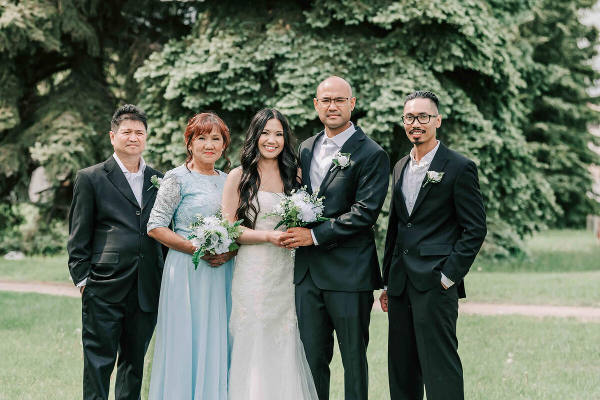 Bride and groom stand with brides family.