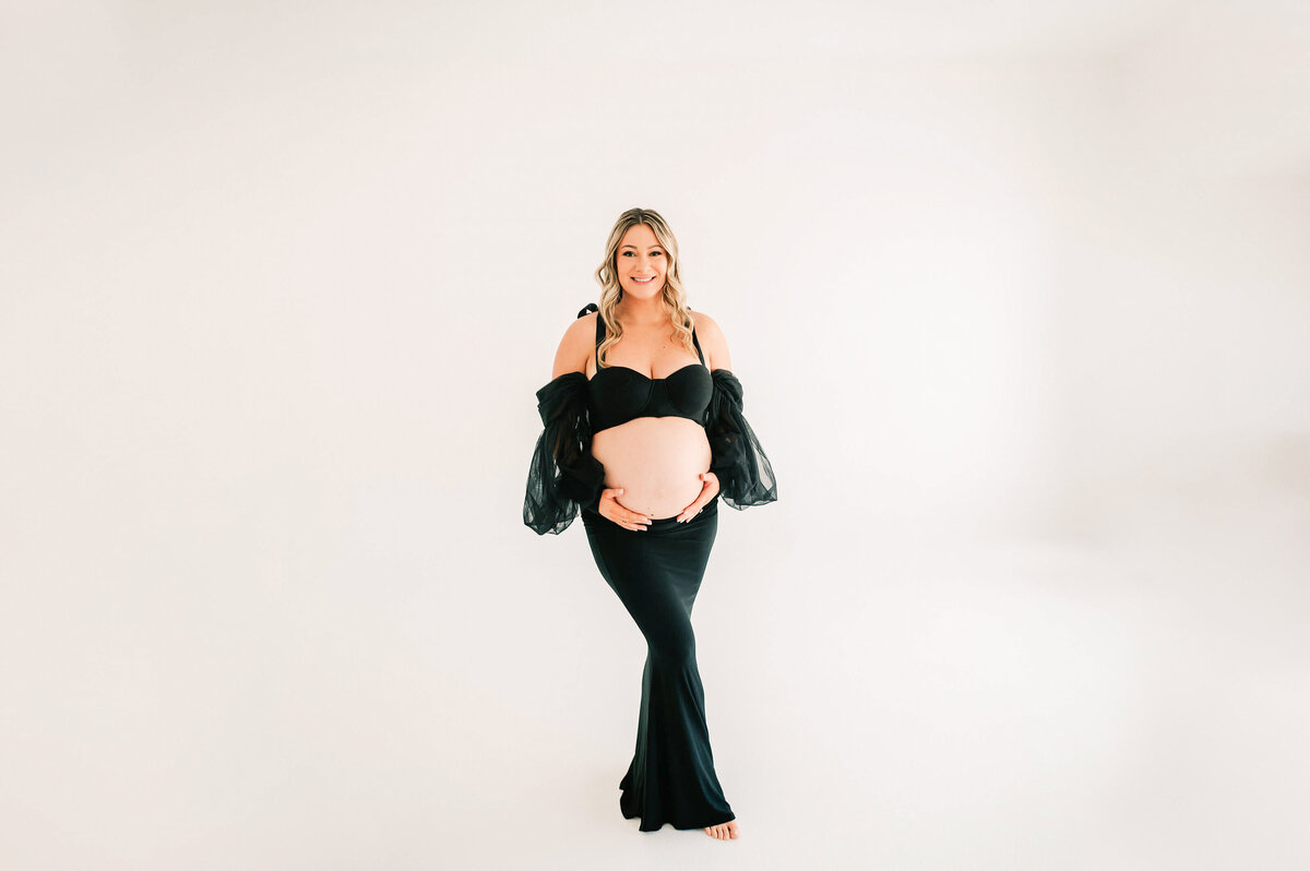 Springfield Mo maternity photography of pregnant mom smiling in black dress