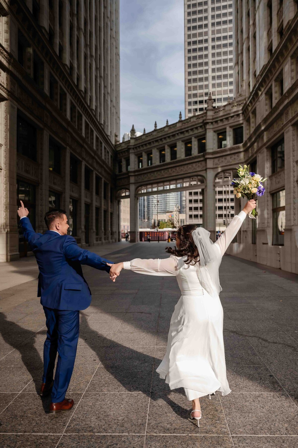 Bride and groom celebbrate at the Wrigley Building