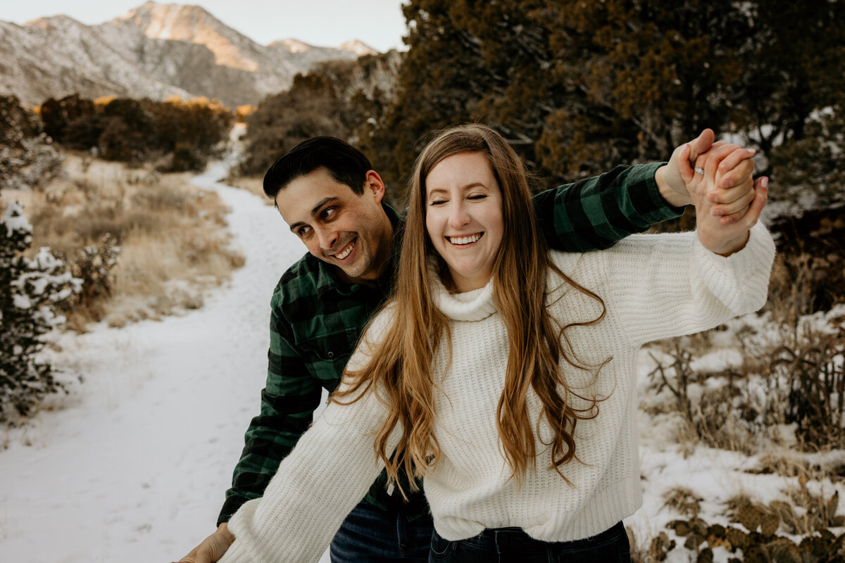 couple walking on the  snowy Sandia foothills in Albuquerque